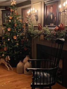 a living room with a christmas tree in the corner and decorations on the fireplace mantel