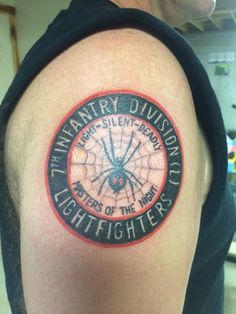 a man with a tattoo on his arm that reads, twenty - seven division lights of the mind