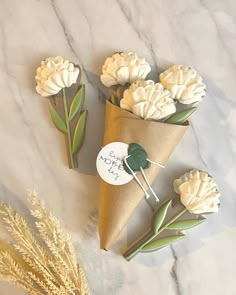 some flowers are sitting in cones on a marble counter top with a price tag attached to them