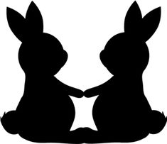 two rabbits sitting next to each other holding hands