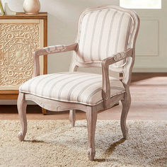 a chair sitting on top of a rug in a living room next to a dresser