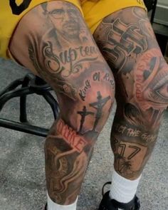 a man with tattoos on his legs and knee