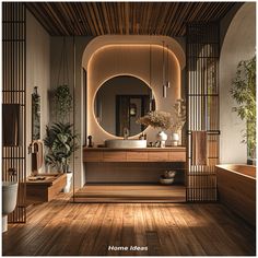 a bathroom with wood flooring and large round mirror