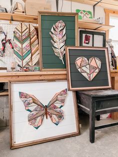 several framed art pieces are on display in a shop