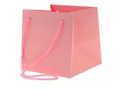 a pink shopping bag on a white background with a pink ribbon hanging from the handle