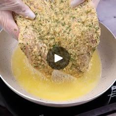 a person is cooking food in a pan on the stove with a video screen showing how to cook it