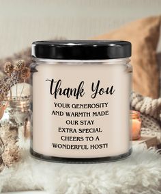 a candle with the words thank you on it next to some candles and other items