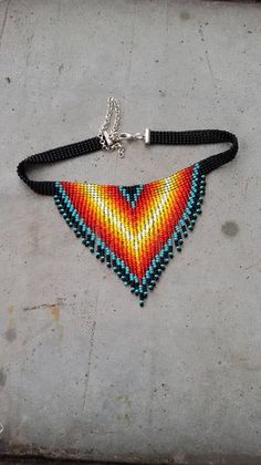 a colorful beaded necklace on a metal chain