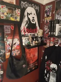 a room filled with lots of different items and posters on the wall, including a black bag