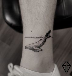 a small whale tattoo on the ankle