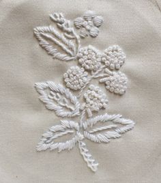 an embroidered piece of cloth with flowers on it