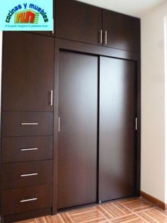 an empty room with wooden floors and brown closets on the wall, next to a window