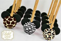 chocolate covered strawberries are lined up with zebra print designs on them, along with bamboo sticks