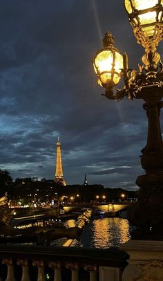 the eiffel tower is lit up at night