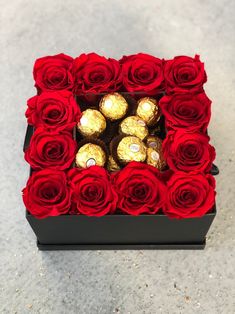 a box filled with red roses and chocolates