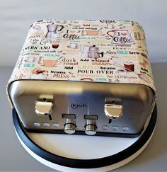 a toaster oven sitting on top of a white counter next to a black and white plate