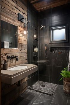 a bathroom with black tile and wood walls