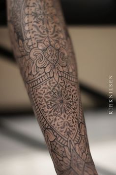 a close up of a person's leg with tattoos on it