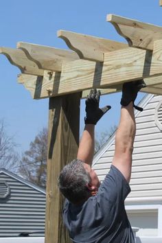 a man is working on a wooden structure