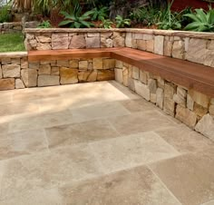 a stone bench sitting in the middle of a garden