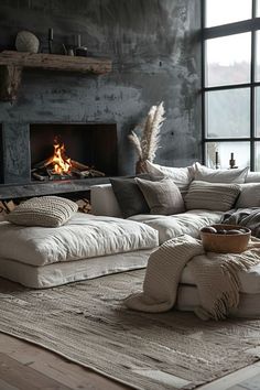 a living room filled with furniture and a fire place in the wall next to a window