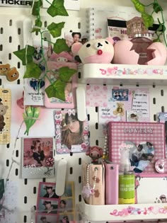 there are many items on the shelves in this room that is decorated with pink and white flowers