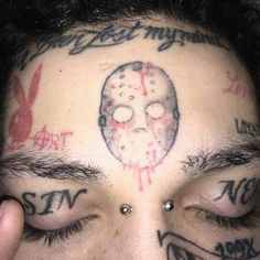 a man with tattoos on his head and eyes