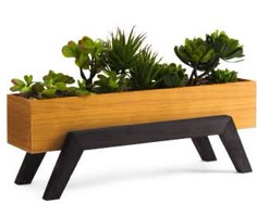 a wooden planter with plants in it