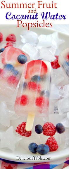 an ice lolly with berries and blueberries on it is sitting on some ice