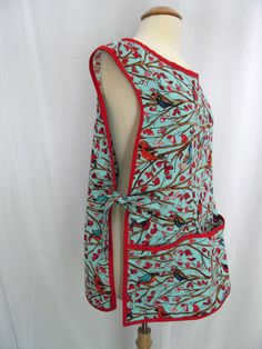 a mannequin wearing a blue and red top with birds on it's back