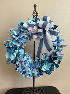 a blue and white wreath on top of a table