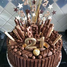 a birthday cake with chocolate frosting and decorations