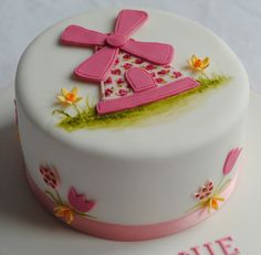 a white cake with pink decorations on it