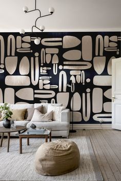 a modern living room with black and white wallpaper