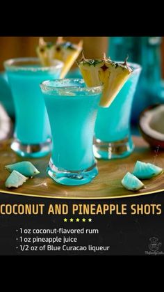 two glasses filled with blue curaco and pineapple shots