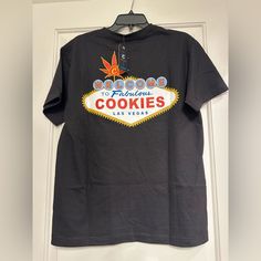 a black t - shirt with the las vegas welcome to fabulous cookies sign on it