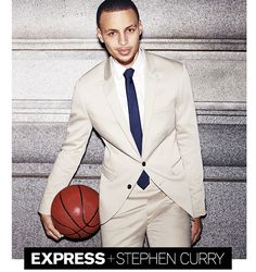 a man in a suit and tie holding a basketball