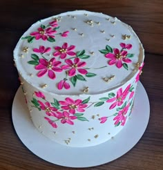 a white cake with pink flowers on it