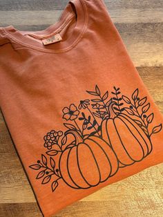 Pumpkins & Wildflowers Long Sleeve T Shirt T-shirts are made when ordered, and ship within 5-7 business days, if you need an exact time frame, feel free to message us to provide an exact timeline. If you would like to make any adjustments to the T-shirt please send us a message so we can help design the perfect T-Shirt for you! Care: Machine Wash in Cold water. tumble dry low or hang dry. We can also make any of our stickers into mugs or shirts, so check out all the options! Looking for other fun gifts, check out our Etsy shop for others t-shirts, stickers, bookmarks, mugs and more! Fall Shirt Ideas Vinyl, Fall T Shirt Design Ideas, Sublimation Ideas, Autumn T Shirts, Vinyl Shirts, Pumpkin Shirt, Fun Gifts, Fall Shirt, Pumpkin Design