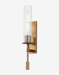 a wall mounted light with a glass cylinder on it's side and a wooden base