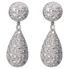 Important platinum pavé-set dangle earrings consisting each of half a sphere that bears the clip-on mechanism and a pear-shaped drop, both fully set with diamonds which are unusually big for a pave setting. That gives these drop earrings a sparkling and extremely precious appearance. The dangling drops can be removed, allowing the upper part to be worn more casually. The make is excellent, and the diamonds are high-quality: These are clearly a dazzling piece of haute-joaillerie. Details: Diamond Luxury Teardrop Diamond White Diamond Earrings, Huge Diamond Earrings, Luxury Glamorous Earrings With Pave Setting, Luxury Diamond White Cluster Drop Earrings, Large Drop Earrings, Big Diamond, Pave Setting, Emerald Earrings, Diamond Drop Earrings