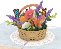 a basket filled with lots of flowers on top of a table