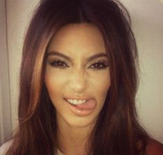 a close up of a person with long brown hair and an open smile on her face