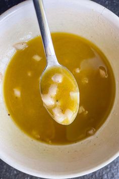 a white bowl filled with soup and a spoon