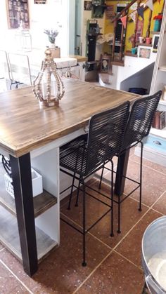 a kitchen table with four chairs around it