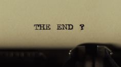 an old typewriter with the word the end written on it's paper and a mouse