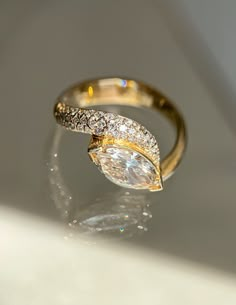 two gold rings with white diamonds on them