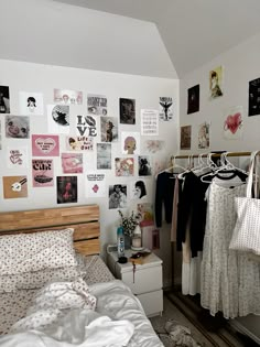 a bed room with a neatly made bed and lots of pictures on the wall