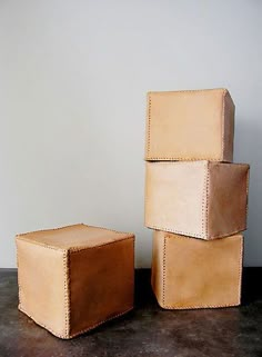 three leather boxes stacked on top of each other