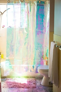 a bathroom with a shower curtain, toilet and bathtub in the middle of it